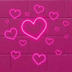 Pink neon hearts on a bright pink concrete block wall.